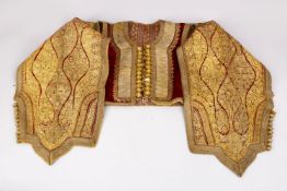 A GOOD TURKISH OTTOMAN CHILDS ROBE OR WAISTCOAT, IN VELVET WITH GOLDEDN THREAD EMBROIDERY.142cm