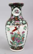 A CHINESE FAMILLE NOIR PORCELAIN VASE, decorated with scenes of figures interior and with floral