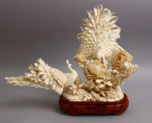A FINE QUALITY JAPANESE MEIJI PERIOD CARVED IVORY OKIMONO - TWO PEACOCKS, finely depicted one with