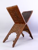 A GOOD ISLAMIC CARVED WOODEN QURAN STAND, carved with foliate decoration, closed, 76cm high x 26cm