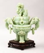 A GOOD CHINESE CARVED JADE TRIPOD CENSER, COVER & STAND, the censer carved with twin lion dog