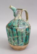 A 12TH / 13TH CENTURY PERSIAN KASHAN TURQUOISE POTTERY EWER, 25cm high.