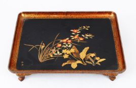 A GOOD JAPANESE MEIJI PERIOD LACQUER TRAY ON FEET, the tray decorated with scenes of native flora,