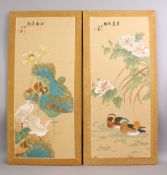 A CHINESE PAIR OF PAINTED PANELS ON TEXTILE / SILK, the decoration depicting birds upon trees,