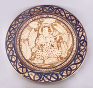 A GOOD 19TH CENTURY ISLAMIC PERSIAN POTTERY PLATE, the central decorated with an immortal /