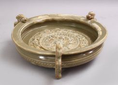 A CHINESE MING STYLE LONGQUAN CARVED LION AND DRAGON FOOTED PORCELAIN BOWL, the interior decorated