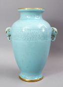 A GOOD CHINESE CELADON MOULDED TWIN HANDLE VASE, the bodyw ith carved archaic style decoration