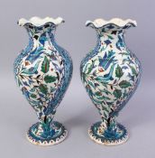 A PAIR OF 19TH CENTURY TURKISH OTTOMAN KUTAHIYA BALUSTER SHAPE VASES, painted in the Iznik style,