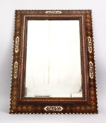 A 19TH CENTURY SPANISH MORESQUE INLAID CALLIGRAPHIC WOODEN MIRROR, the frame with exotic wood inlay,