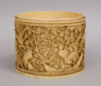 A 19TH CENTURY JAPANESE CARVED IVORY TUSK SECTION, depicting cranes and cherry blossom, 8cm.