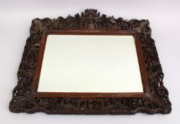 A FINE 19TH CENTURY CHINESE CANTON CARVED WOOD MIRROR, the frame of the mirror decorated with