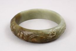 A GOOD CHINESE CARVED JADE BANGLE, carved with chilong, 7cm.