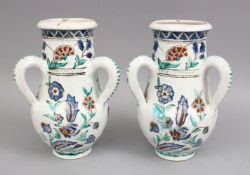 A PAIR OF IZNIK STYLE POSS EUROPEAN POTTERY TRIPLE HANDLED VASES, each vase with three moulded
