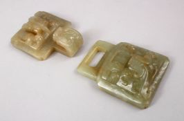 A CHINESE CARVED JADE BELT BUCKLE, carved in archaic form, 14cm.