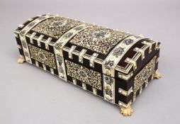 AN INDIAN EBONY AND IVORY DOMED SHAPED CASKET AND COVER, on claw feet, 10ins long.