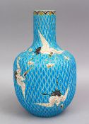 A JAPANESE TURQUOISE GROUND MOULDED CRANE VASE, depicting flying cranes upon turquoise bead body,