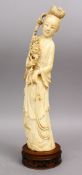 A 19TH CENTURY CHINESE CARVED IVORY FIGURE OF GUANYIN, holding a bouquet, 36cm high.