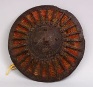A GOOD 17TH CENTURY TURKISH OTTOMAN STEEL AND WOVEN SHIELD, 28cm.