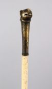 A 19TH CENTURY INDIAN MUGHAL TIGER HEAD MOUNTED WHALE BONE SWAGGER STICK, 82cm.
