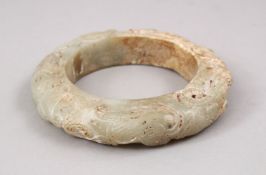 A LARGE CHINESE CARVED JADE ARCHAIC FORM BANGLE, 10CM.