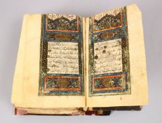 AN EARLY LEATHER BOUND COPY OF THE QURAN, 6 ins x 4 ins.