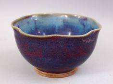 A GOOD CHINESE JUN WARE PORCELAIN MOULDED BOWL, with graduating colour glaze, 16.5cm diameter.