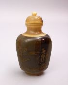 A 19TH CENTURY CHINESE CARVED HORN SNUFF BOTTLE, with gilt calligraphy and landscapes, 8cm.