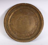 A 19TH CENTURY INDAIN BRASS CHARGER / DISH, with embossed decoration, 23cm