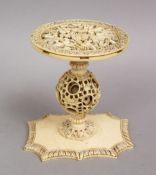 A 19TH CENTURY CHINESE CANTON CARVED IVORY PUZZLE BALL STAND, 9CM.