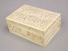 A GOOD 19TH CENTURY CHINESE CANTON CARVED IVORY LIDDED BOX, carved in relief to depict figures aside