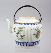 A 19TH CENTURY CHINESE FAMILLE ROSE PORCELAIN RIBBED TEAPOT, with floral decoration, 12cm high x