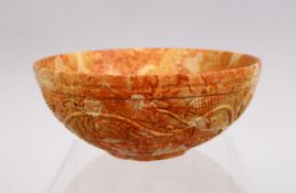 A FINELY CARVED INDIAN MUGHAL STONE BOWL, The body carved with foliage, 12cm.