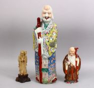 A LARGE CHINESE FAMILLE ROSE PORCELAIN FIGURE OF A MAN, the fiigure with an impressed tongzhi mark