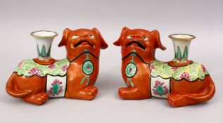 A GOOD PAIR OF 19TH CENTURY CHINESE CORAL RED FAMILLE ROSE PORCELAIN LION DOG CANDLESTICKS,