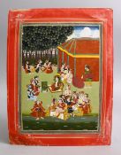 AN INDIAN MUGHAL MINIATURE PAINTING OF FIGURES SEATED IN A GARDEN, 31CM X 24CM
