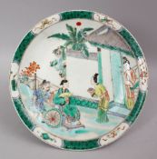 A CHINESE KANGXI STYLE FAMILLE VERTE PORCELAIN DISH, the dish depciting scenes of figures in