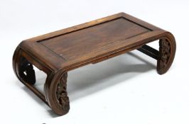 A 19TH CENTURY CHINESE HARDWOOD SCROLL END OPIUM TABLE, with open ends and carved frieze, 32cm