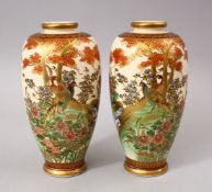 A GOOD PAIR OF JAPANESE MEIJI PERIOD CERAMIC VASES, each vase upon a beige ground with typical