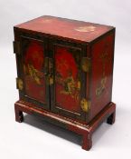 A 19TH CENTURY ORIENTAL / CHINESE RED LACQUER DECORATED TWO DOOR CHEST ON STAND, decorated with