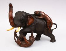 A JAPANESE BRONZE ELEPHANT AND TIGER GROUP OKIMONO, the elephant being attacked by two tigers,