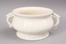 A CHINESE BLANC DE CHINE PORCELAIN INCENSE BURNER, with twin moulded handles. 17cm wide.