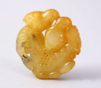A GOOD CHINESE CARVED JADE ROUNDEL OF A CHICKEN AND TWO CHICKS, 5cm.