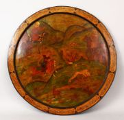 A GOOD 19TH CENTURY PERSIAN PAPIER MACHE PAINTED ROUND PANEL, with calligraphy reading 