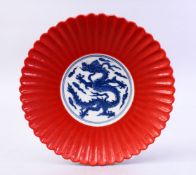 A GOOD CHINESE MING STYLE CORAL GROUND MOULDED PETAL PORCELAIN DISH, the dish with a blue & white