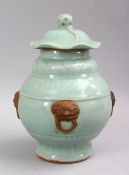 A CHINESE CELADON LONGQUAN PORCELAIN GINGER JAR & COVER, decorated with four moulded lion handles.