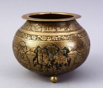 A GOOD ISLAMIC BRASS TRIPLE FOOT CALLIGRAPHIC BOWL, with panels of figures and bands of calligraphy,