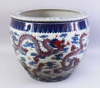 A LARGE 19TH / 20TH CENTURY CHINESE BLUE, WHITE & IRON RED PORCELAIN JARDINIERE, the body