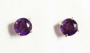 A PAIR OF 9CT GOLD AND AMETHYST STUDS.