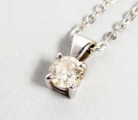 AN 18CT WHITE GOLD AND DIAMOND PENDANT on a chain.