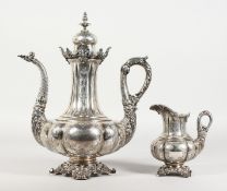 A SUPERB CONTINENTAL SILVER COFFEE POT AND MILK JUG, possibly GERMAN, with engraved body, cast spout